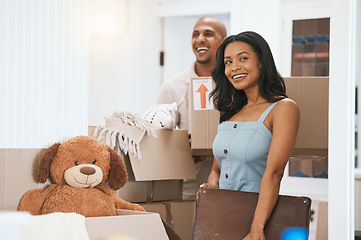 Image showing Happy couple, real estate and moving in new home for renovation, property investment or relocation together. Man and woman realtor carrying boxes or luggage in the house with smile for mortgage loan