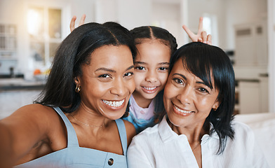 Image showing Peace sign selfie, grandmother and child with mother in home living room, bonding or having fun. Family, smile and portrait of girl with grandma and mom, face or take photo with v hand emoji together