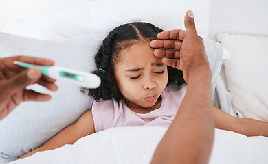 Image showing Parent, hands and thermometer with sick little girl checking fever, temperature or flu for cold in bed at home. Hand of adult monitoring kid for illness, healthcare or virus in love, care or support