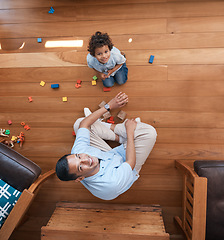 Image showing Portrait, toys and top view of father with kid on floor for playing, educational games and learning. Child development, family home and above of happy dad and young boy for fun, bonding and love