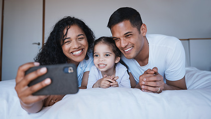 Image showing Smile, family and selfie on bed in bedroom, bonding and having fun together. Photo, happiness and kid, mother and father taking pictures for social media, happy memory and profile picture in house.