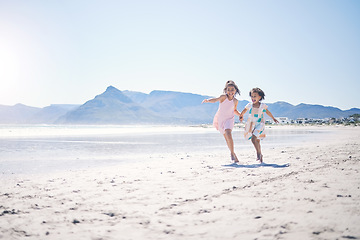 Image showing Girl kids, holding hands and run at beach with space for mockup by water, together and bond with love in summer. Female children, play game or race for siblings, family and ocean mock up in sunshine