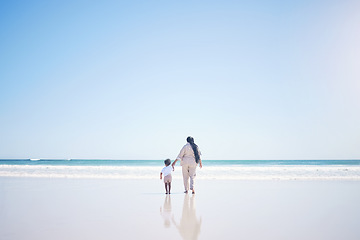 Image showing Mother, son and beach with back, space and mock up with blue sky, lens flare and bonding with love in summer. Mama, male kid and holding hands for care, vacation and sea mockup with waves in sunshine