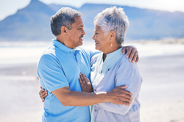 Image showing Senior couple, hug and sea vacation outdoor with love and romance in nature. Ocean, elderly and old woman and man together on summer holiday by the sea feeling happiness and relax on a beach