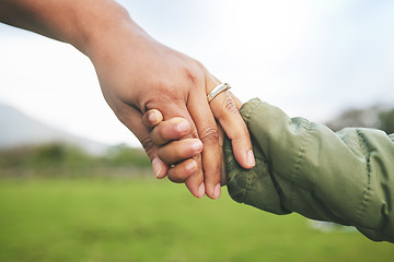 Image showing Closeup, mother and child holding hands in park, morning walk and bonding with trust, support and love. Woman, kid and helping hand walking in nature for quality time in sunshine and holiday together