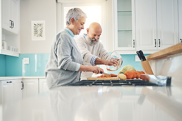 Image showing Cooking, nutrition and a senior couple in the kitchen of their home together during retirement for meal preparation. Health, wellness or food with a mature man and woman making supper in their house