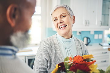 Image showing Love, gift and senior couple with flowers, smile and loving at home, bonding and romance. Romantic, man and woman with floral present, celebrate anniversary and relationship with joy and quality time