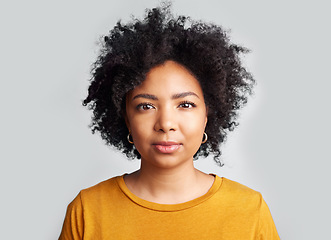 Image showing Serious, woman and portrait in studio, white background and confident on backdrop. Face of young female model with curly hair, afro and cool attitude in casual fashion, style or gen z of South Africa