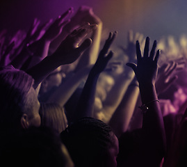 Image showing Hands, lights and people at rock concert or music festival with neon lighting, energy and dancing at live event. Dance, fun and group of excited fans in arena at band performance or crowd at party.