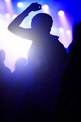 Image showing Dance, neon and silhouette of woman at music festival with crowd dancing at concert, lights and energy at live event. Party, fun and group of people, excited fans in arena at rock band performance.