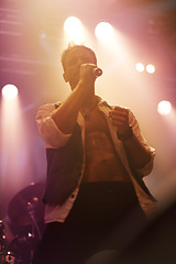 Image showing Concert, music and singer with man on stage for night, festival and rock performance. Spotlight, karaoke and band with male artist singing in show for musician, clubbing and disco party event