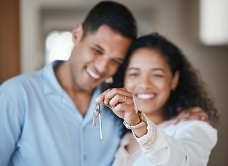 Image showing House keys, new home or happy couple hug in real estate, property investment or buying an apartment. Blurred, love or Indian man hugging an excited woman to celebrate goals or moving in together