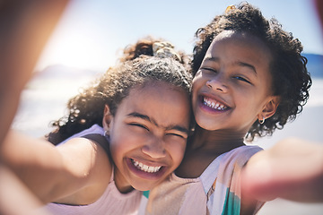 Image showing Girl children, hug and selfie at beach with smile on face, sunshine or friends with fun, travel or summer on social media. Female kids, siblings or photography for profile picture, vacation or family