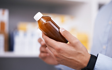 Image showing Pharmacy, medicine and hands of man with bottle reading label for medication, prescription and information. Healthcare, clinic and closeup of person with medical product, supplements and antibiotics