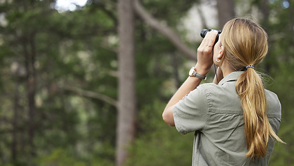 Image showing Binoculars, forest and woman explore in nature, travel journey or outdoor adventure for carbon footprint research. Watch, search and back person birdwatching in jungle, woods or eco green environment