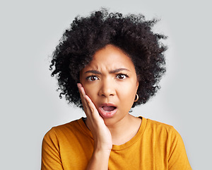 Image showing Omg, wow and confused woman with hand on face in studio confused, surprised and open mouth on grey background. Wtf, portrait and African female shocked, by news, gossip or rumor, drama or secret