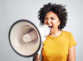 Image showing Megaphone, speech and angry woman in studio for message, broadcast or screaming for freedom. Speaker, microphone and girl protest for change, democracy or justice or womens rights on grey background