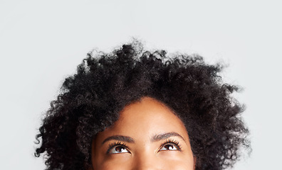 Image showing Woman, eyes looking up and cropped in studio with thinking, ideas and hope by gray background. Young female model, african girl and think for mindset with afro, vision and daydream by backdrop