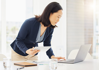 Image showing Tablet, research and laptop with business woman in office for planning, online report and email. Technology, communication and connection with asian female employee for corporate, idea and review