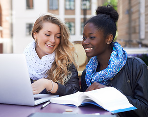 Image showing Communication, women students at campus with laptop and book. Teamwork or collaboration, females working together on university or college assignment and friends laughing or smiling at table