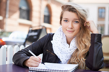 Image showing Art, portrait and woman drawing in the city in a notepad for a creative college assignment. Happy, smile and young female artistic student creating a picture in a book for university project in town.