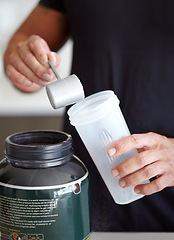 Image showing Man, hands and preparing protein shake for nutrition, muscle gain or body mass product and supplement. Hand of male bodybuilder making pre workout or powder drink for exercise or healthy meal at home