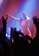 Image showing People hands, singer woman and concert at night performance, singing and gen z in lights, celebration or cheers. Musician person on stage and microphone at event with fans, crowd or audience dancing