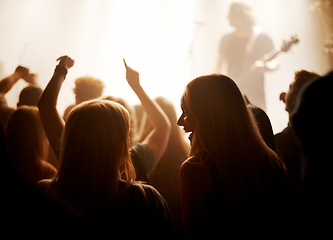 Image showing Excited women, friends and fans at music festival, lights and crowd in silhouette at live band performance on stage. Happiness, people with smile and lighting, excitement at rock concert together.