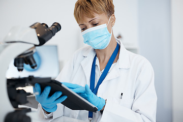 Image showing Scientist, tablet and woman with mask in research for cure, results or data at the laboratory. Female medical or science professional working on technology in forensics for scientific search in a lab