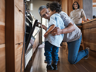 Image showing Senior man baking with his grandchild in the kitchen while bonding with love, care and happiness. Cooking, family time and elderly male person in retirement working oven with a boy kid in modern home