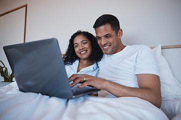 Image showing Love, laptop and happy couple relax in bed, bonding and enjoying streaming, movie or browsing in their home. Online, film and man with woman in a bedroom for weekend, entertainment and subscription