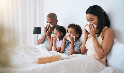 Image showing Sick, flu and family on a bed, tissue and blowing nose with illness, disease and cold at home. Parents, mother and father with siblings, children and kids in a bedroom, allergy and health issue