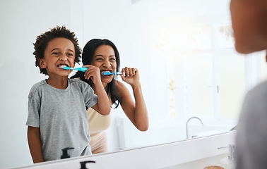 Image showing Learning, mother and son brushing teeth, dental hygiene and wellness at home, bathroom and bonding. Family, female parent or mama with male child, kid or boy with oral health, cleaning mouth or smile