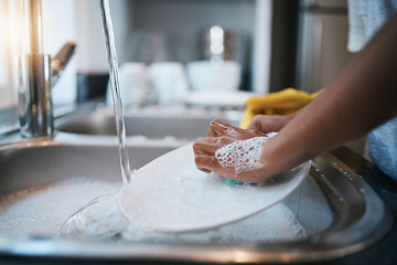 Image showing Hands, sink and cleaning dishes with a person in the kitchen of a home to wash a plate for hygiene. Water, bacteria and soap with an adult washing porcelain crockery in a house to clean for housework