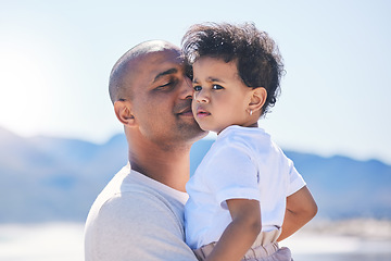 Image showing Father kiss, baby and beach with love and parent support on summer holiday with kids. Blue sky, ocean and young boy with his dad feeling trust and happiness on vacation by the sea with family