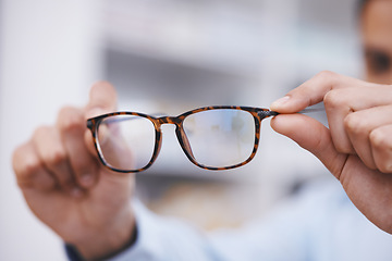 Image showing Optometry, hands and optician with glasses for choice, eyesight and frame decision. Giving, showing and a man holding prescription eyewear for a fitting, vision and service during a consultation