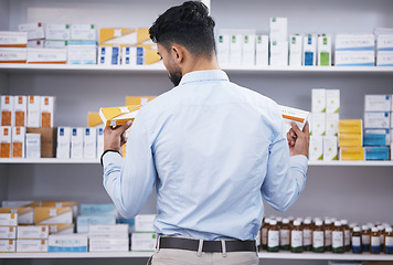 Image showing Pharmacy, medicine and man with pills choice for medication, prescription and treatment. Healthcare clinic, drug store and male person reading boxes for medical product, supplements and antibiotics