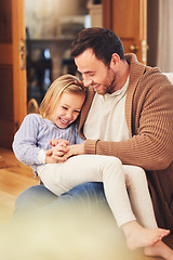 Image showing Father, girl on lap and laughing in home, playing and bonding together. Dad, happiness and child or daughter laugh at funny joke, humor or comic comedy, having fun and enjoying quality time with care