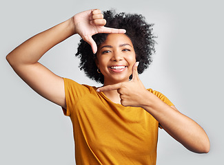 Image showing Portrait, finger frame and happy woman in white background, studio and review profile picture. Face, young female model and hands to border perspective, cool selfie and smile for creative photography