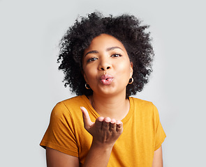 Image showing Portrait, woman and blowing kiss in white background, studio and backdrop of love, romance and flirting lips. Happy african female model, air kissing and emoji for happiness, joy and valentines day