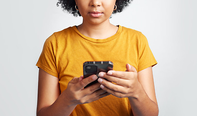 Image showing Woman, hands and texting on cellphone in studio for notification, social media post and online chat. Closeup female model typing on smartphone, mobile app download and technology on white background