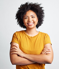 Image showing Portrait of happy, woman, arms crossed and confident in studio, white background and backdrop. Young african female model smile with natural curly hair, positive face and gen z girl of South Africa