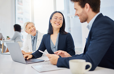 Image showing Teamwork, young asian businesswoman on a laptop and talking to colleagues in an office. Happy diverse businesspeople, coordination or collaboration and planning for success with digital devices