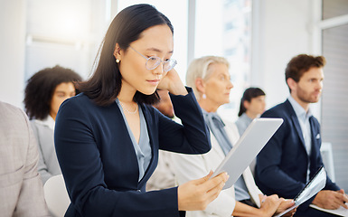 Image showing Conference meeting, tablet and woman reading digital notes, online data or seminar report for business analysis. Tradeshow audience, convention crowd and Asian person review presentation research