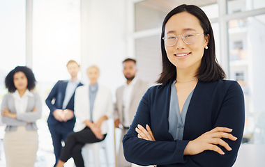 Image showing Business, happy and portrait of Asian woman in office with confidence, pride and motivation with team. Leadership, diversity and female worker with smile for success, company mission and happiness