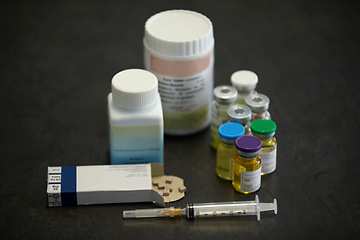 Image showing Medicine container, pills and a syringe or needle on a table for healthcare. Steroids, medical aesthetics and supplements together for bodybuilder muscle growth for testosterone, nutrition and doping