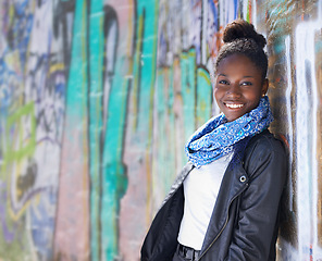 Image showing Portrait, urban fashion and black woman at wall with smile, graffiti and mockup standing at street art. Happiness, youth and happy face of gen z model in African city with streetwear and sunshine.