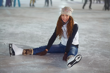 Image showing Woman, ice skater and sitting in portrait with smile for workout, training and exercise for winter sports. Girl, skating rink and happiness for sport, skate or fitness with excited face for lifestyle