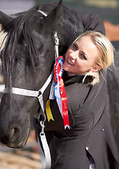 Image showing Winner, sports and portrait of woman and horse for equestrian, competition and celebration. Happy, smile and animal show with female jockey and stallion with ribbon for achievement and performance