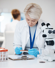 Image showing Science woman, blood test and medical analysis in laboratory for scientist investigation or research. Person writing dna results, sample or study in lab for biotechnology innovation or development